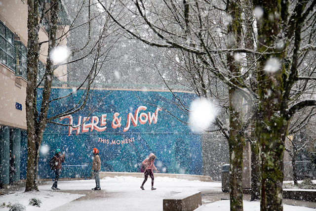 Walking in the snow outside the Here & Now mural by Erica Phillips on March 7, 2019. (Photo by Taehoon Kim)